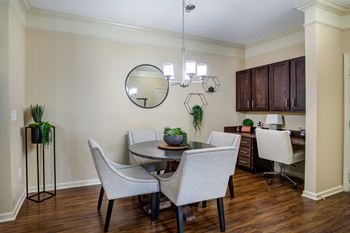 A dining room with a table and chairs